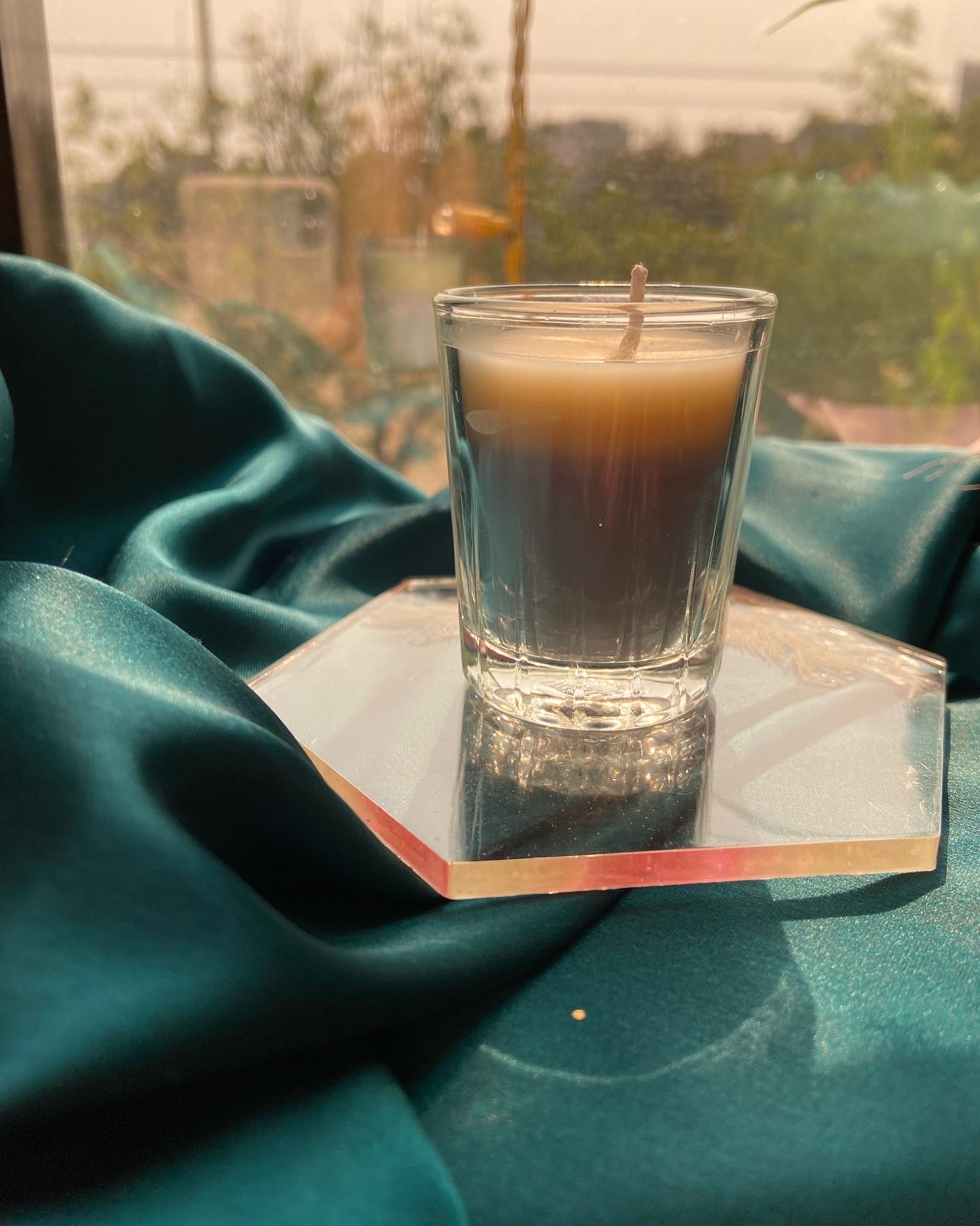 Layered coffee and cream candle on an iridescent resin coaster