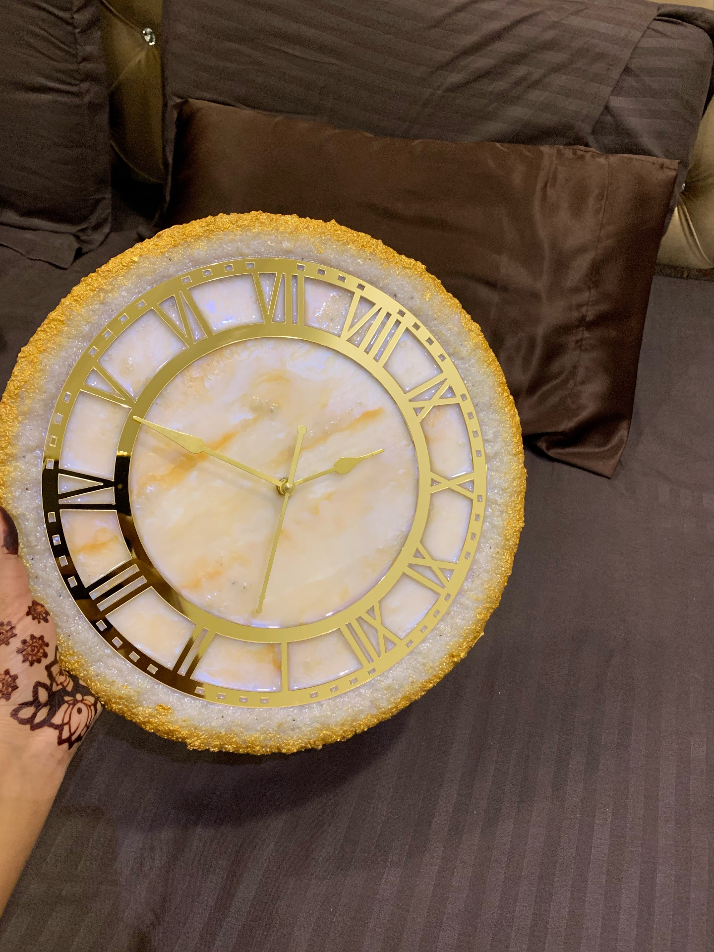 Handmade resin wall clock with gold-flake textured edge and marbled face with Roman numerals