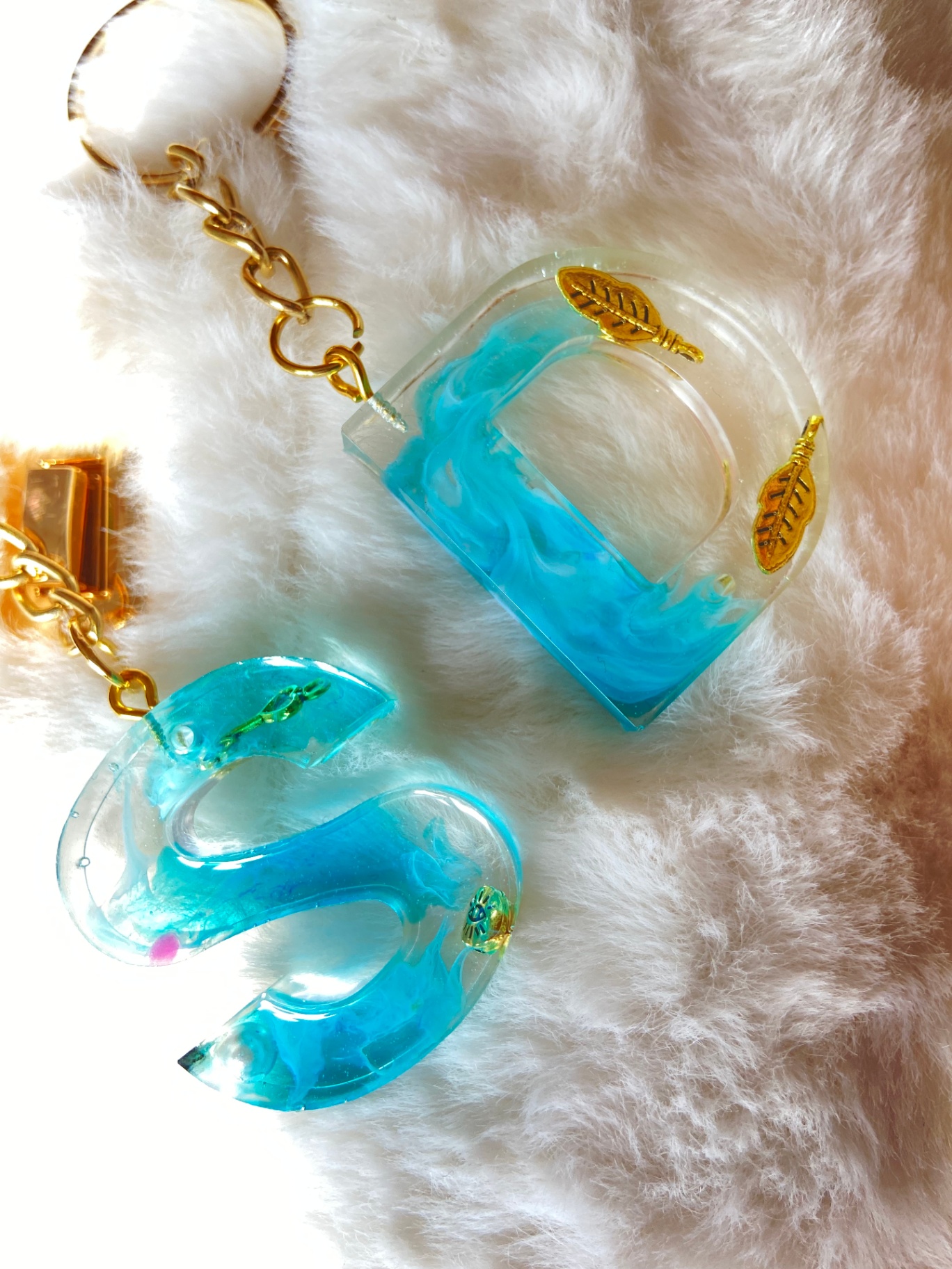 Resin initial keychains in turquoise — letters D and S with gold charms