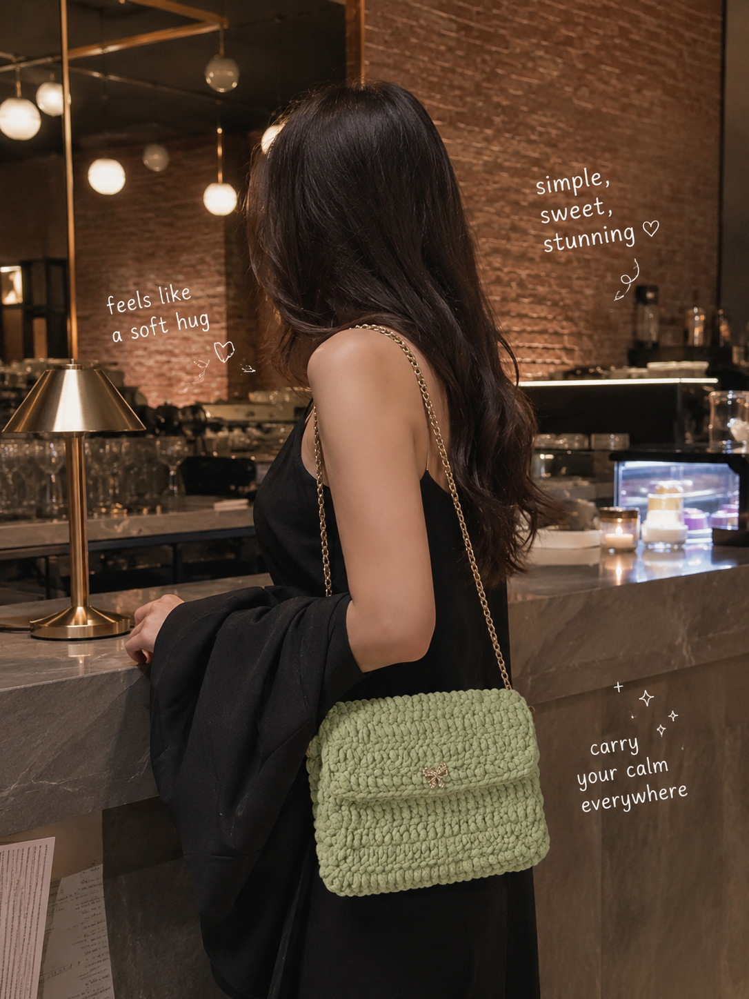 Model carrying a sage green chenille crochet crossbody clutch with gold chain