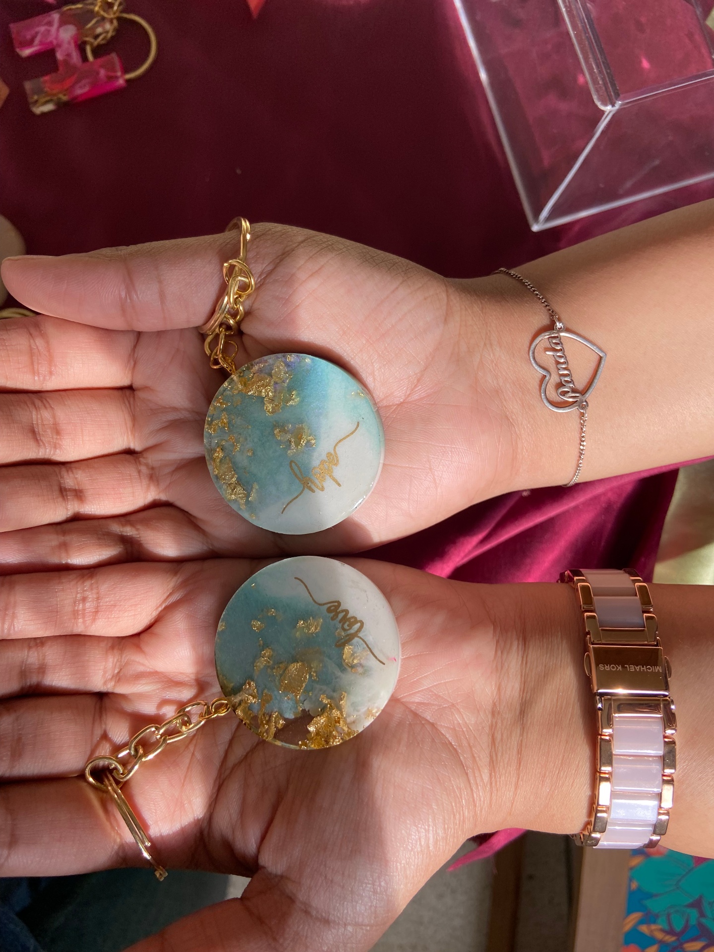 Round resin keychains with hope and love in gold script and gold leaf