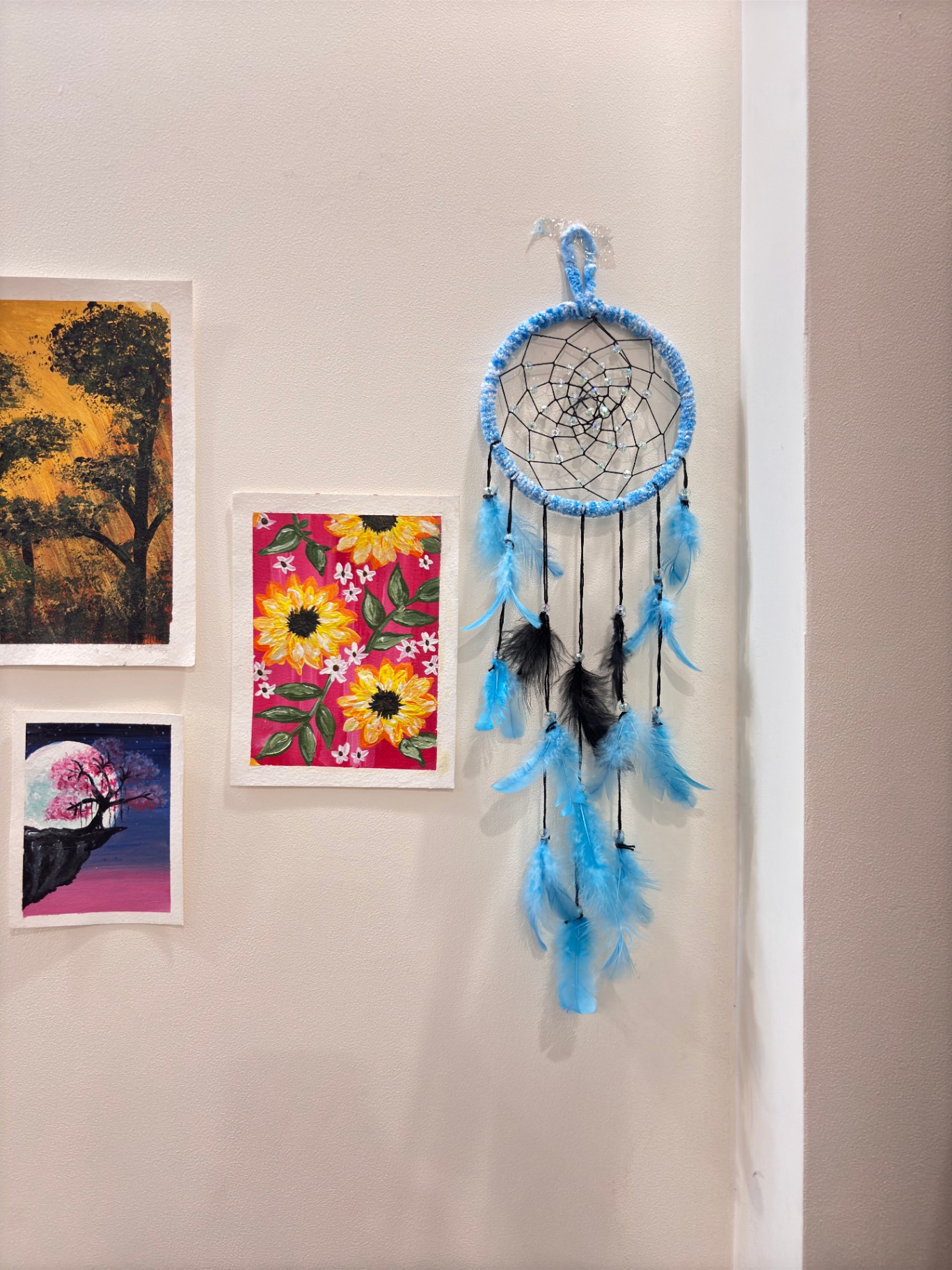 Sky blue dream catcher with black web and blue feathers